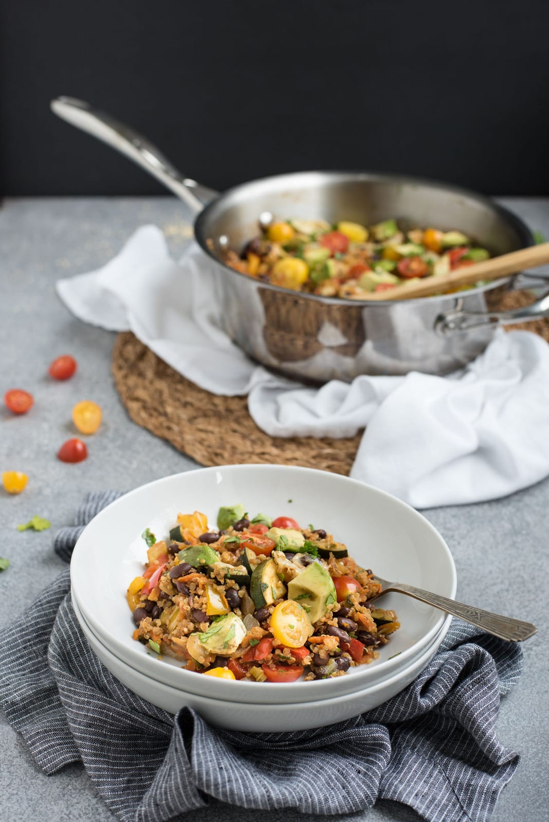 Black bean quinoa casserole in a bowl with pan in background