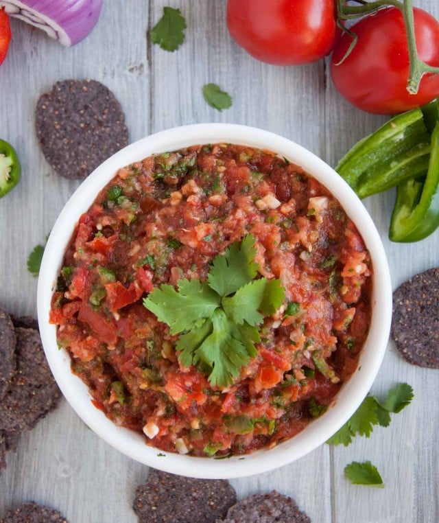 10 minute fresh blender salsa with tomatoes, onion, jalapeño, cilantro and just the right amount of kick to have you coming back for more.