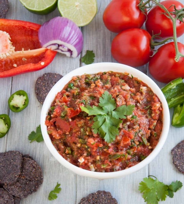 10 minute fresh blender salsa with tomatoes, onion, jalapeño, cilantro and just the right amount of kick to have you coming back for more.