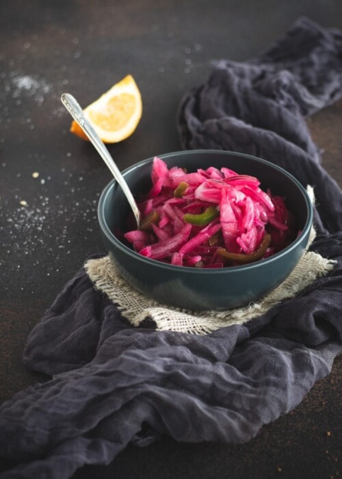 Bowl of pickled red onions with spoon