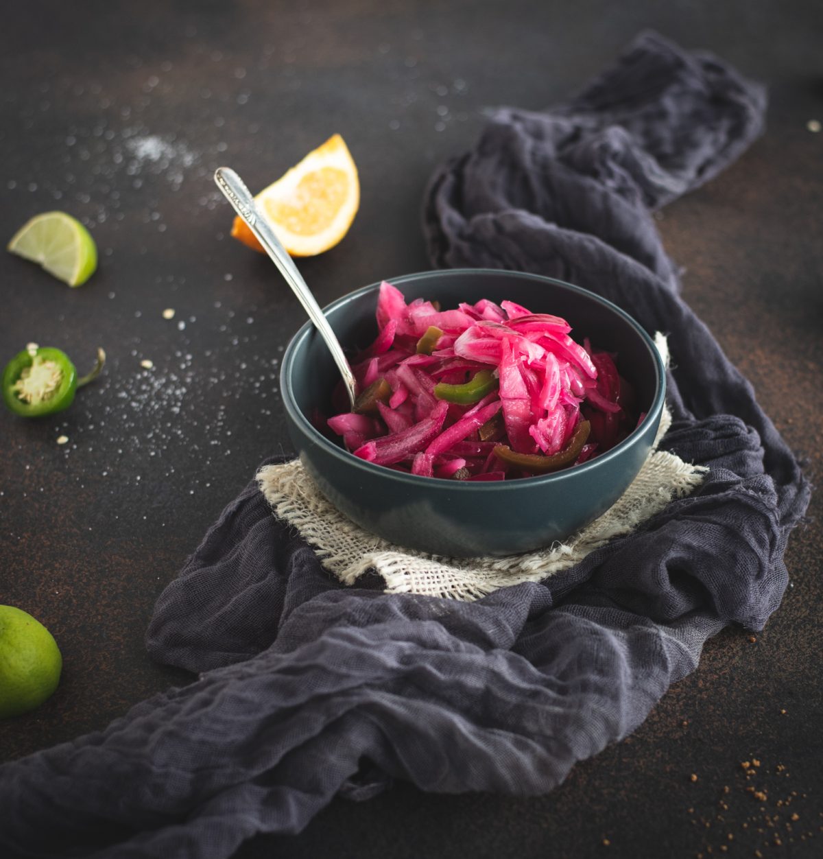 Bowl of pickled red onions with spoon