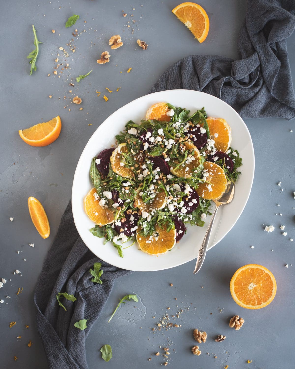 Overhead picture of arugula salad with roasted beets and orange slices