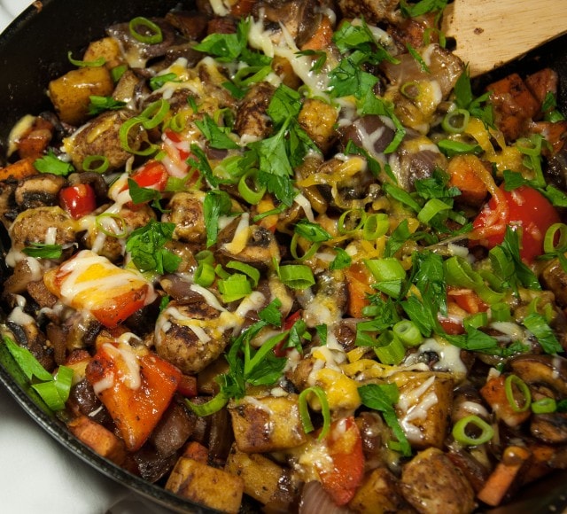 This satisfying ooey gooey cheesey potato skillet is the ultimate comfort food made lighter with sweet potato, red pepper, mushrooms, and fresh herbs. 