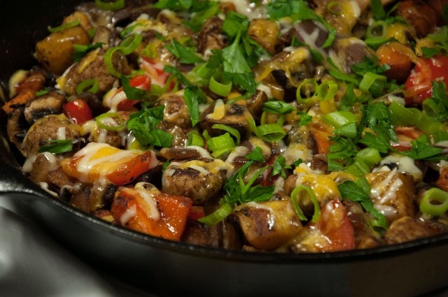 This satisfying ooey gooey cheesey potato skillet is the ultimate comfort food made lighter with sweet potato, red pepper, mushrooms, and fresh herbs. 