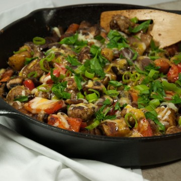 This satisfying ooey gooey cheesey potato skillet is the ultimate comfort food made lighter with sweet potato, red pepper, mushrooms, and fresh herbs.