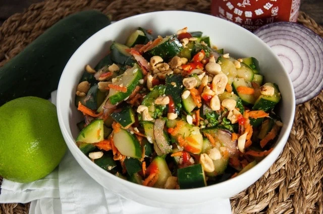 Thai cucumber salad with tangy lime, fresh cilantro and a hint of spice will rock your taste buds. Perfect paired with other Thai dishes or on its own- Yum!