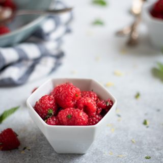 Photo of bowl with Raspberries with lemon zest and mint