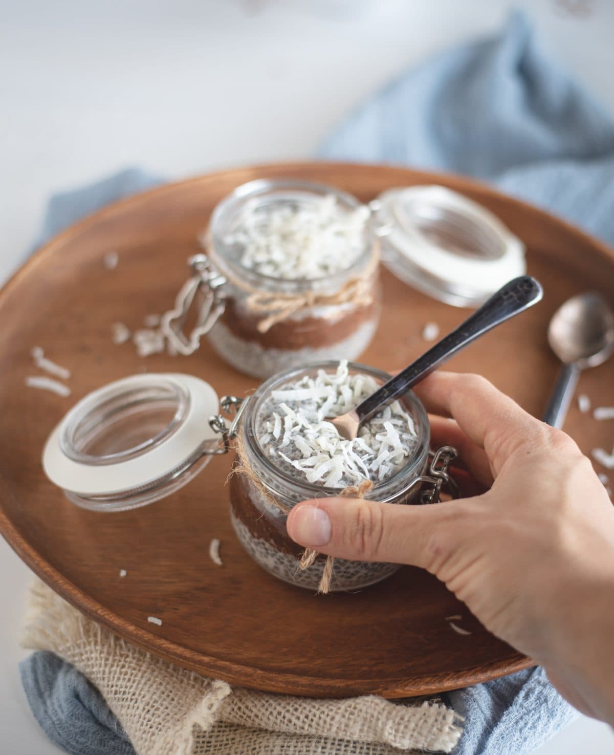 Hand holding jar of Almond joy chia seed pudding