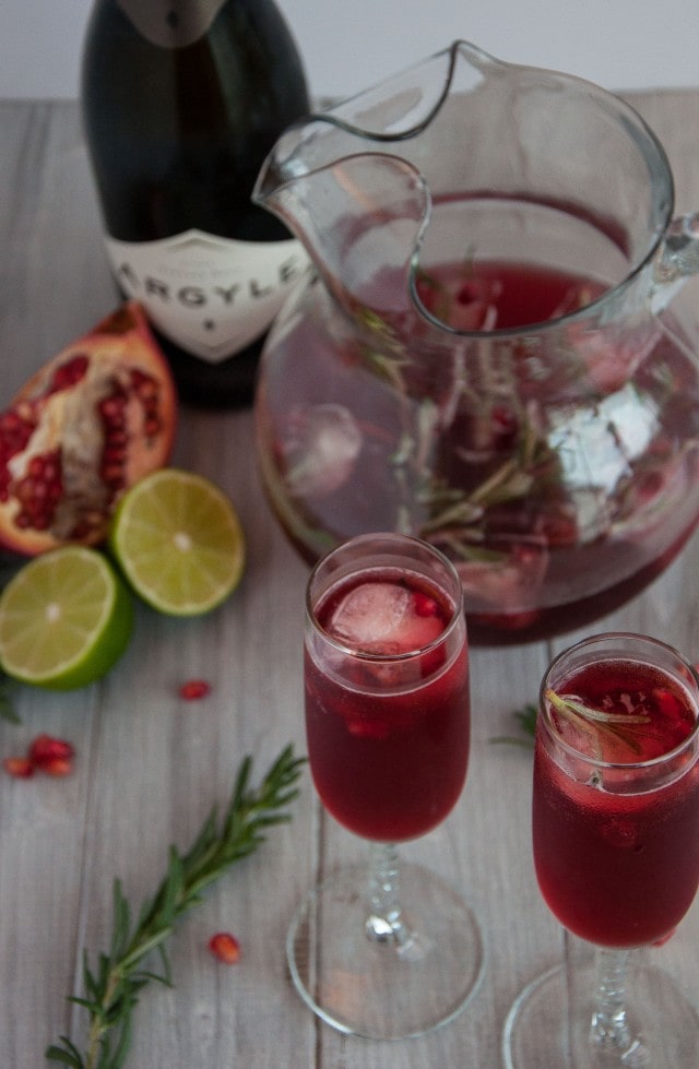 Rosemary pomegranate mimosas encapture the essence of relaxed holiday gatherings where festive simplicity leaves more time to enjoy with family and friends.