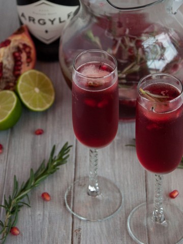 Rosemary pomegranate mimosas encapture the essence of relaxed holiday gatherings where festive simplicity leaves more time to enjoy time with family and friends.