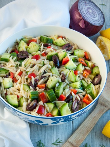 Delicious cucumber salad is loaded with orzo, red pepper, and kalamata olives tossed in a refreshing lemon dill dressing.