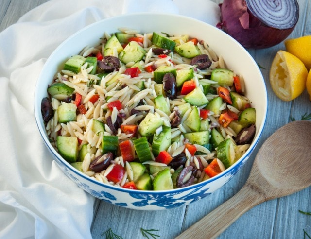 Delicious cucumber salad is loaded with orzo, red pepper, and kalamata olives tossed in a refreshing lemon dill dressing.