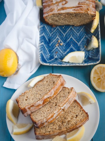 Loaf of Whole Wheat Lemon Poppy Seed Bread with slices on plate