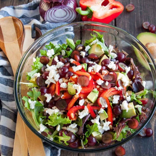 curry balsamic dressing on a bowl of green salad with grapes
