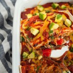These shredded chicken enchiladas are so insanely delicious! Peppers, chicken, cheese, sour cream and homemade sauce unite in this tasty main dish.