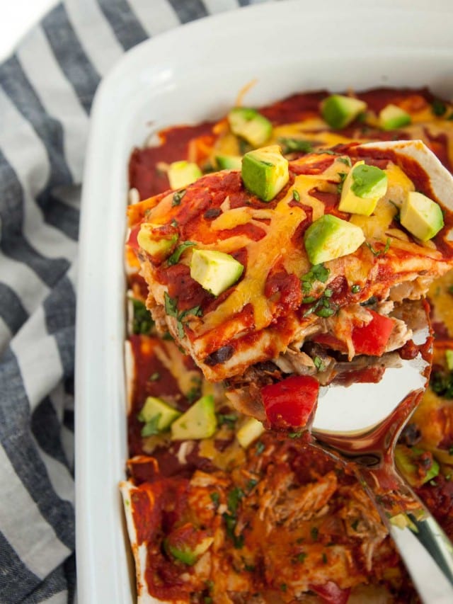 These shredded chicken enchiladas are so insanely delicious! Peppers, chicken, cheese, sour cream and homemade sauce unite in this tasty main dish.