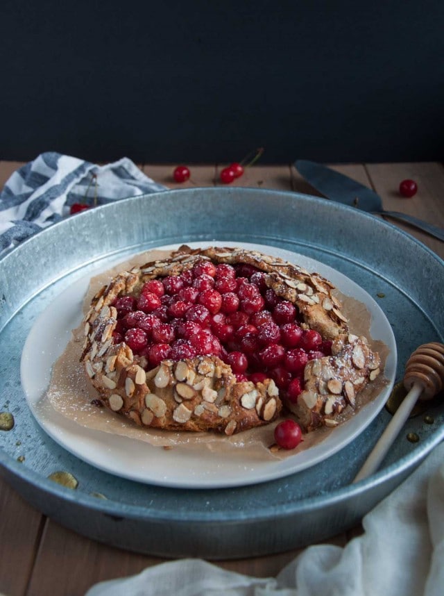 In this tasty sour cherry galette, tart cherries and heart healthy almonds come together in a nutritious whole wheat and almond flour crust for a perfect healthy desert.