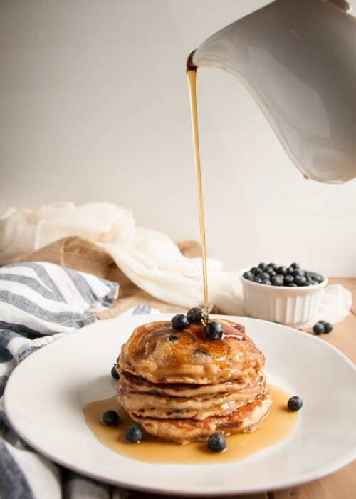 These thick, rich, delicious pancakes are a breakfast winner both in taste and nutrition, made with whole wheat flour, Greek yogurt, and blueberries.
