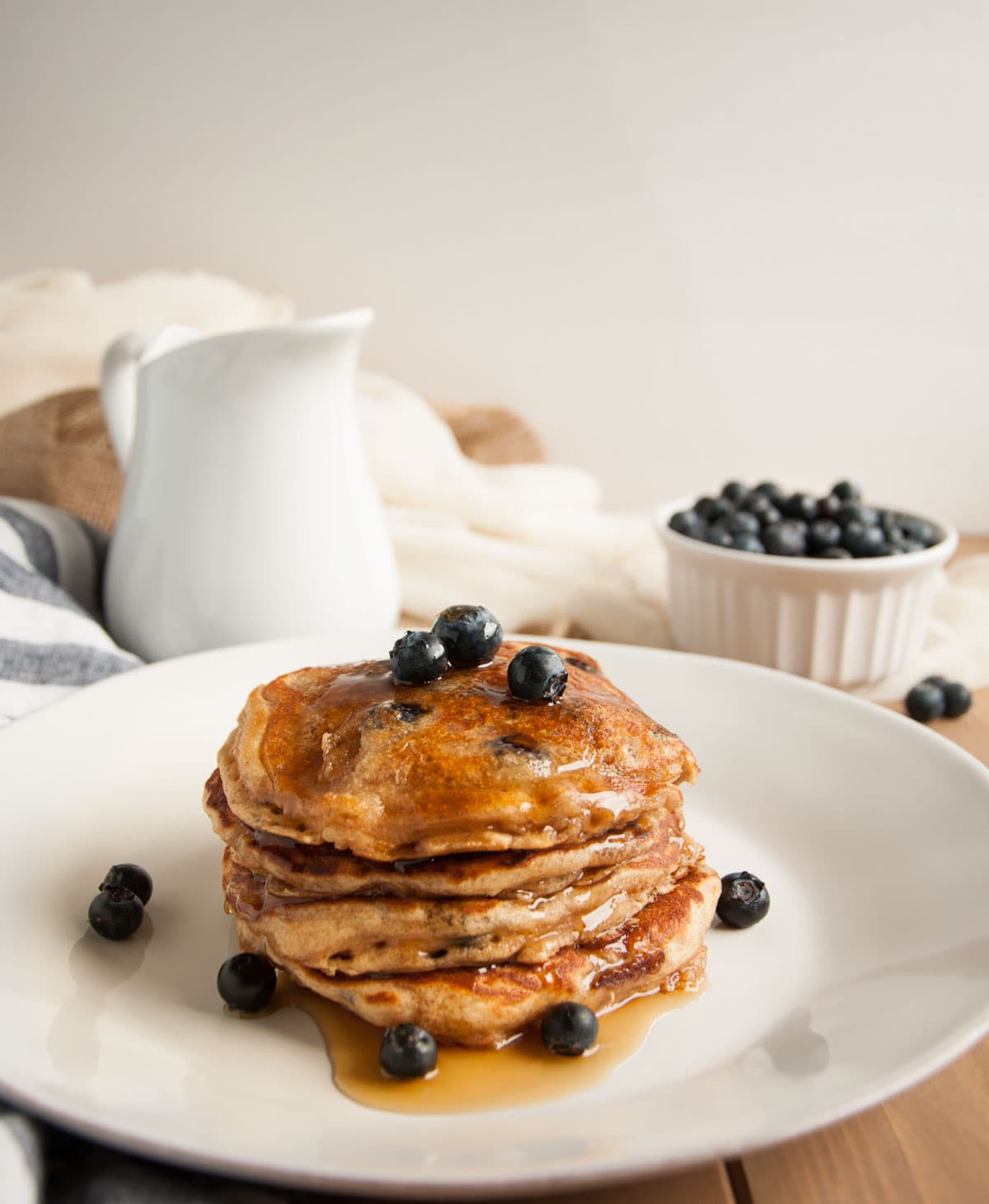 These thick, rich, delicious yogurt pancakes are a breakfast winner both in taste and nutrition, made with whole wheat flour, Greek yogurt, and blueberries.