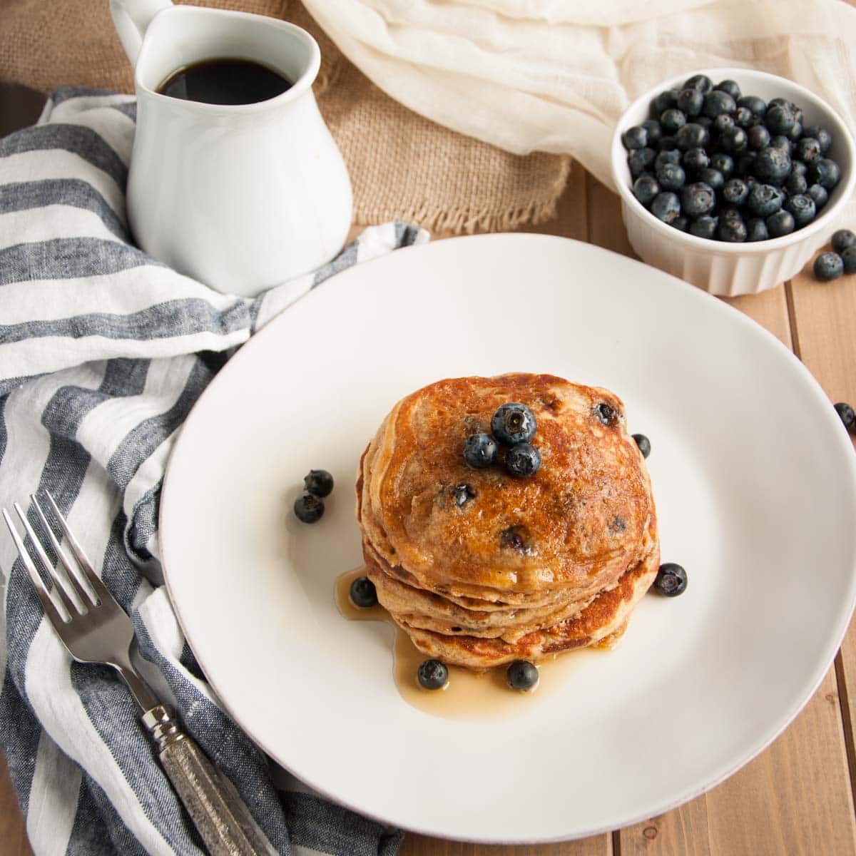 These thick, rich, delicious yogurt pancakes are a breakfast winner both in taste and nutrition, made with whole wheat flour, Greek yogurt, and blueberries.