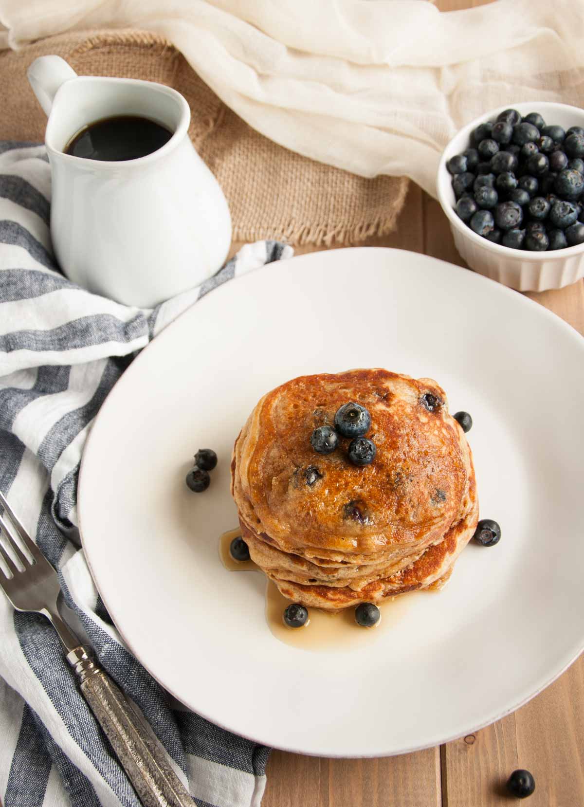 These thick, rich, delicious yogurt pancakes are a breakfast winner both in taste and nutrition, made with whole wheat flour, Greek yogurt, and blueberries.