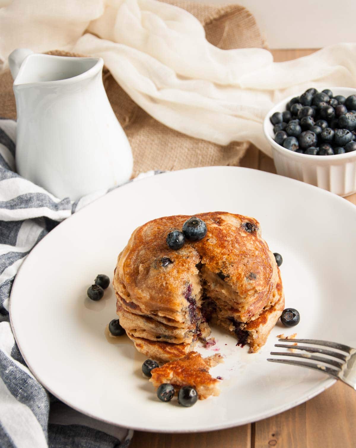 These thick, rich, delicious yogurt pancakes are a breakfast winner both in taste and nutrition, made with whole wheat flour, Greek yogurt, and blueberries.