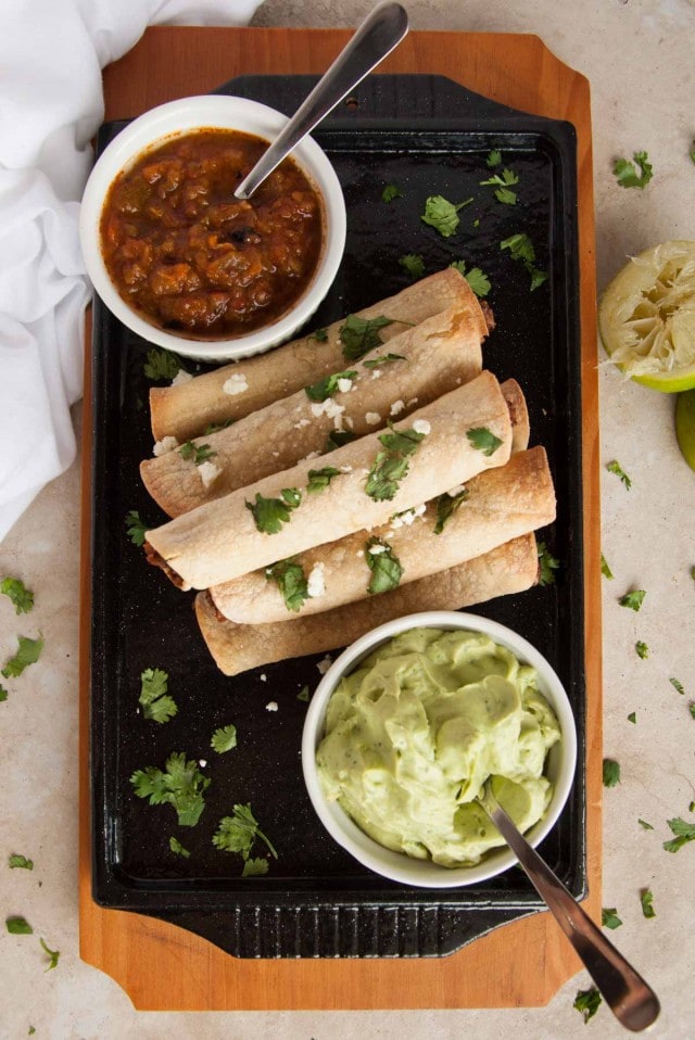 These baked black bean taquitos are both vegetarian, packed with veggies, and way lighter than the store bought kind without sacrificing any flavor.