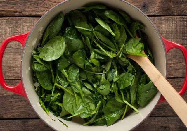 Who knew spinach could taste so good? This quick and easy sauteed spinach recipe is a delicious low calorie side to any main dish and is ready in 15 minutes!