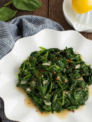 Who knew spinach could taste so good? This quick and easy sautéed spinach recipe is a delicious low calorie side to any main dish and is ready in 15 minutes!
