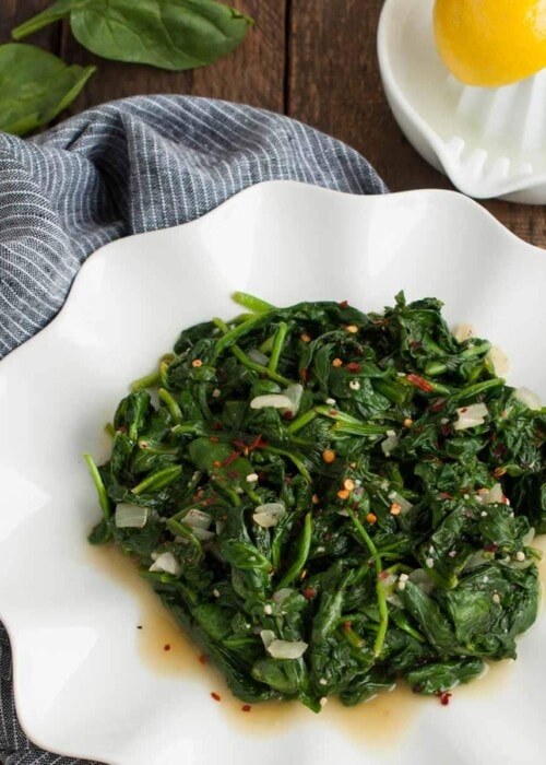 Who knew spinach could taste so good? This quick and easy sautéed spinach recipe is a delicious low calorie side to any main dish and is ready in 15 minutes!