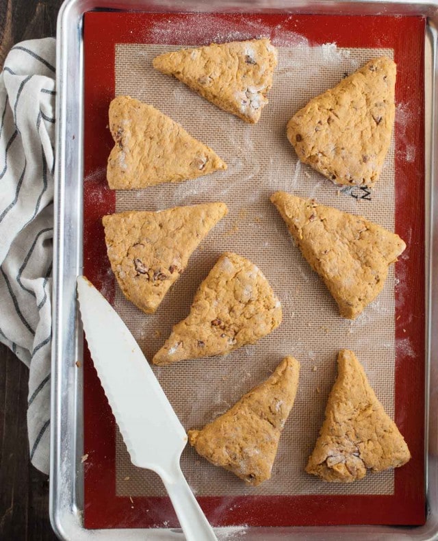 These easy pumpkin scones are both healthy and delicious! They're loaded with pumpkin, toasted pecans, and use whole wheat flour and less sugar. - Feasting Not Fasting