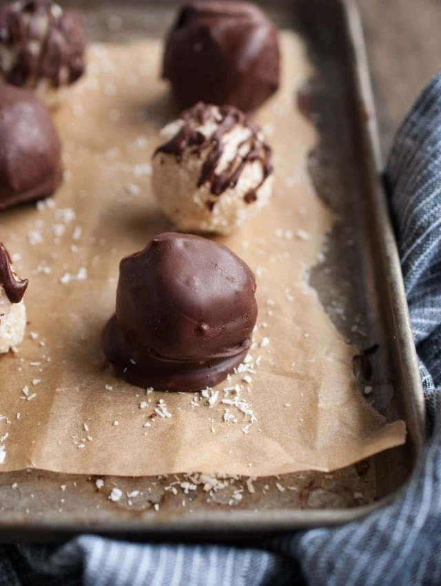 These chocolate coconut balls are made healthier with unsweetened coconut, maple syrup, and coconut oil. They're so delicious you'd never know it though!
