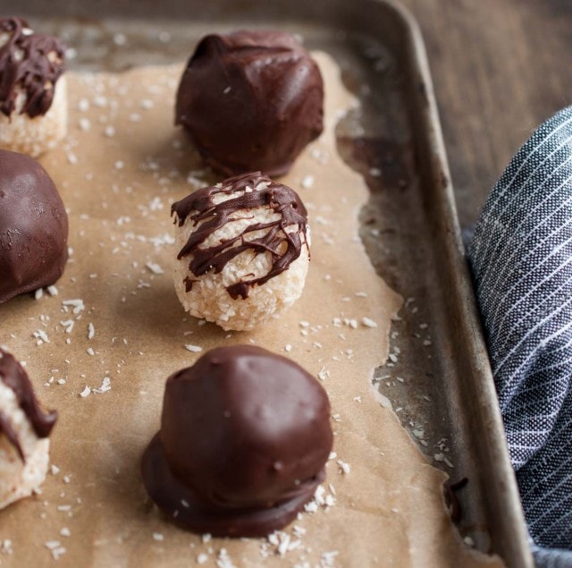 These chocolate coconut balls are made healthier with unsweetened coconut, maple syrup, and coconut oil. They're so delicious you'd never know it though!