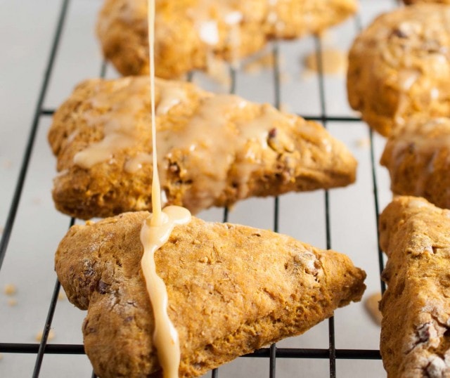 These easy pumpkin scones are both healthy and delicious! They're loaded with pumpkin, toasted pecans, and use whole wheat flour and less sugar. - Feasting Not Fasting