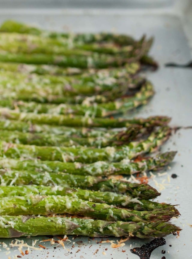 It will take longer for the oven to heat up than to prep this tasty lemon parmesan asparagus! Simple ingredients come together in this classic versatile side dish. - Feasting Not Fasting