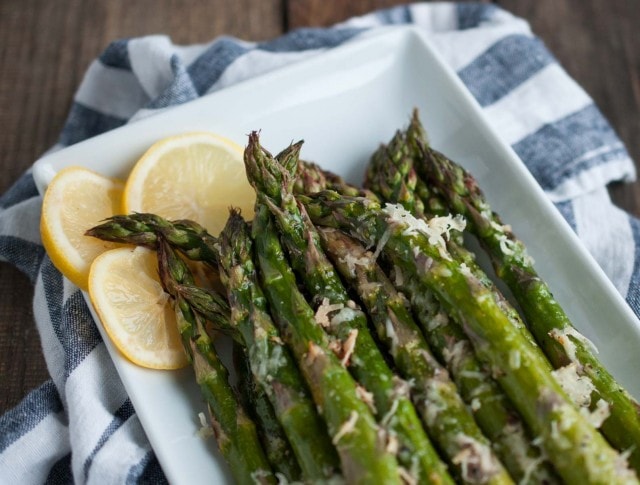 It will take longer for the oven to heat up than to prep this tasty lemon parmesan asparagus! Simple ingredients come together in this classic versatile side dish. - Feasting Not Fasting