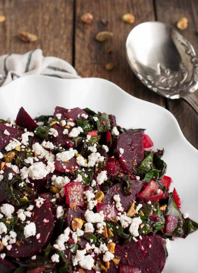 These light, delicious sautéed beet greens are tossed in tangy vinegar and spices before being topped with roasted beets, crushed pistachios, and crumbles of goat cheese.