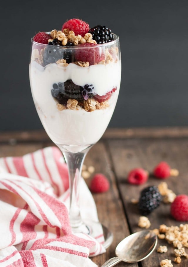 This light and healthy yogurt parfait can be made in five minutes or less with over 14 grams of protein, 9 grams of fiber, and only three ingredients! - Feasting Not Fasting