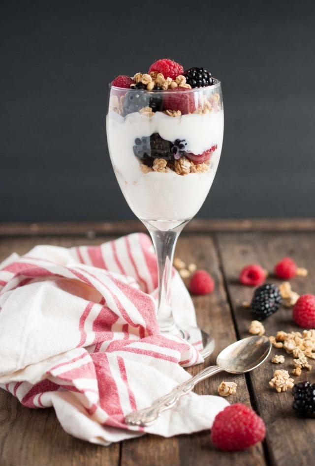 This light and healthy yogurt parfait can be made in five minutes or less with over 14 grams of protein, 9 grams of fiber, and only three ingredients! - Feasting Not Fasting