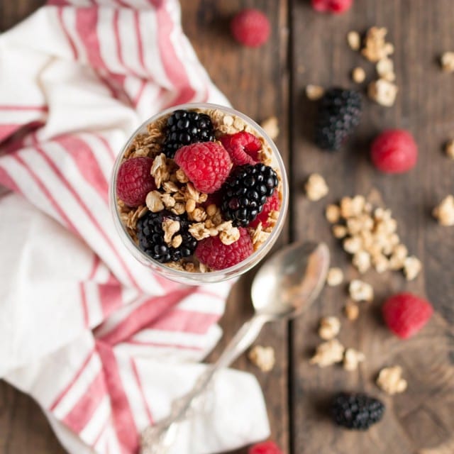 This light and healthy yogurt parfait can be made in five minutes or less with over 14 grams of protein, 9 grams of fiber, and only three ingredients! - Feasting Not Fasting