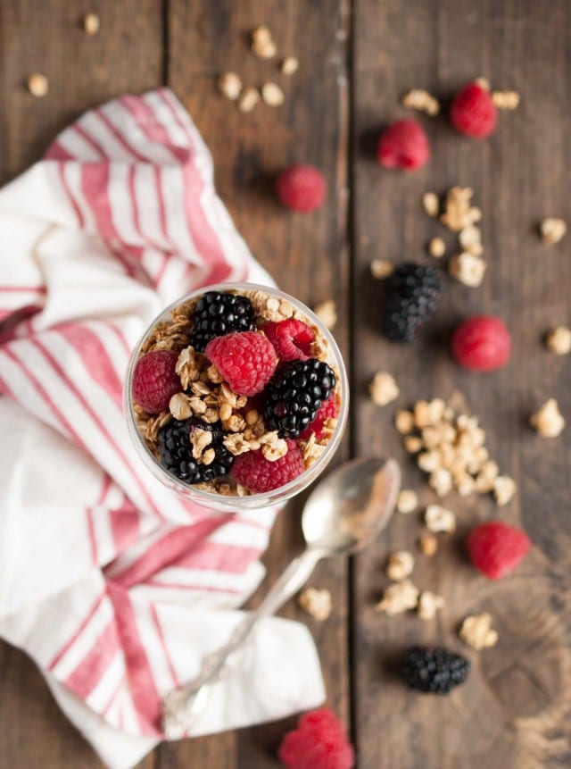 This light and healthy yogurt parfait can be made in five minutes or less with over 14 grams of protein, 9 grams of fiber, and only three ingredients! - Feasting Not Fasting
