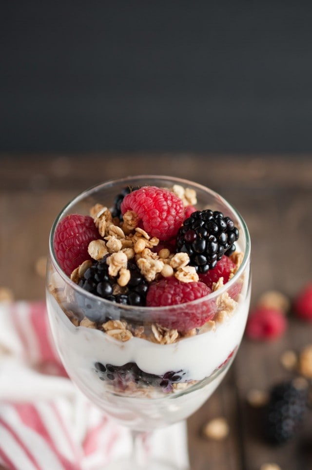 This light and healthy yogurt parfait can be made in five minutes or less with over 14 grams of protein, 9 grams of fiber, and only three ingredients! - Feasting Not Fasting