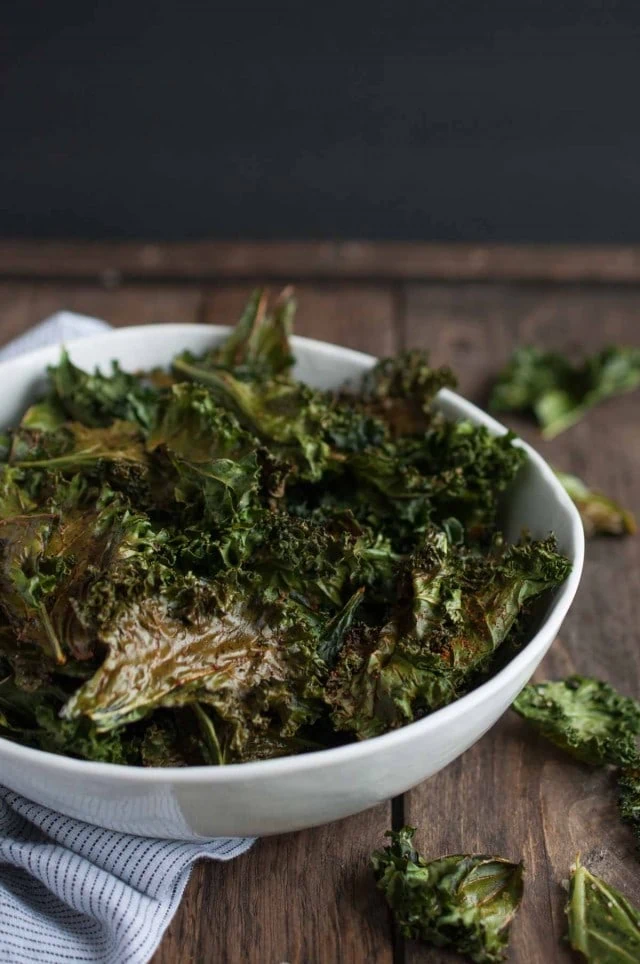 Roasted kale chips are given a touch of cajun spice and then baked until crispy. This recipe makes two generous servings, each with under 100 calories!