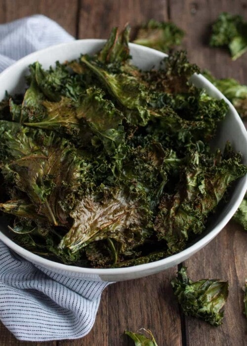 Roasted kale chips are given a touch of cajun spice and then baked until crispy. This recipe makes two generous servings, each with under 100 calories!