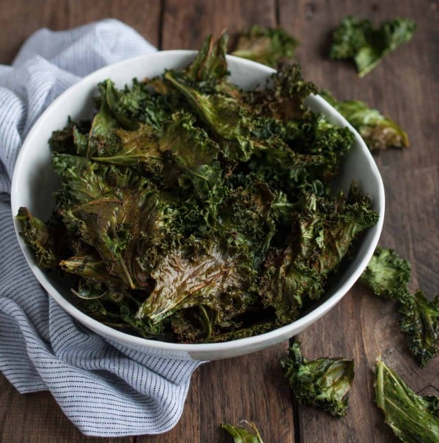 Roasted kale chips are given a touch of cajun spice and then baked until crispy. This recipe makes two generous servings, each with under 100 calories!