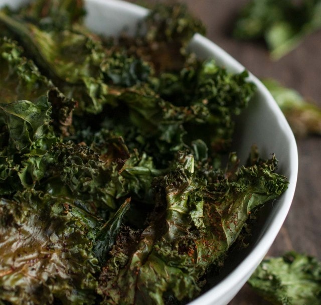 Roasted kale chips are given a touch of cajun spice and then baked until crispy. This recipe makes two generous servings, each with under 100 calories!