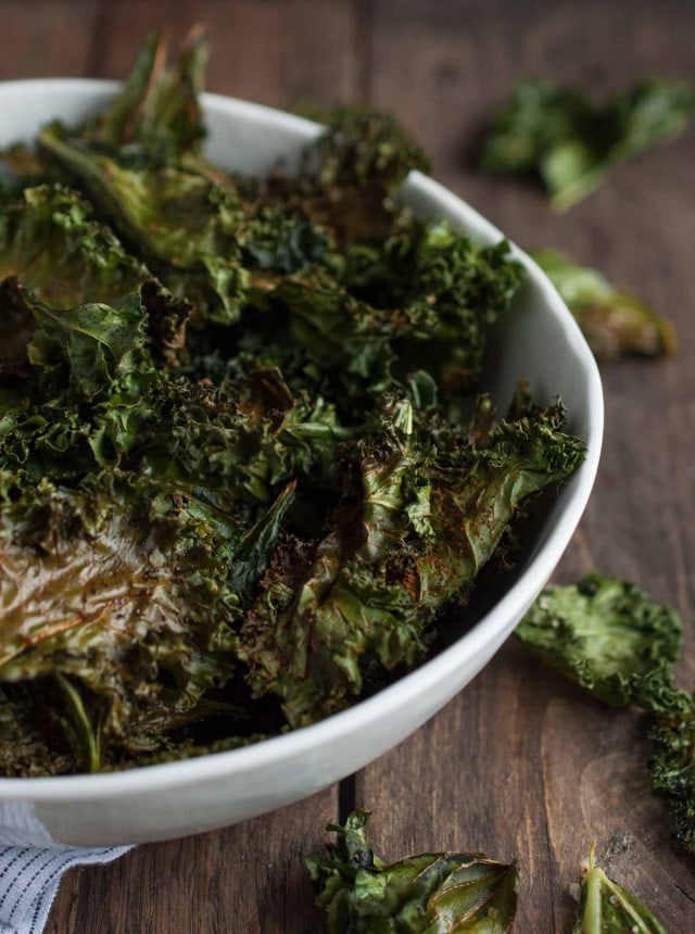 Roasted kale chips are given a touch of cajun spice and then baked until crispy. This recipe makes two generous servings, each with under 100 calories!