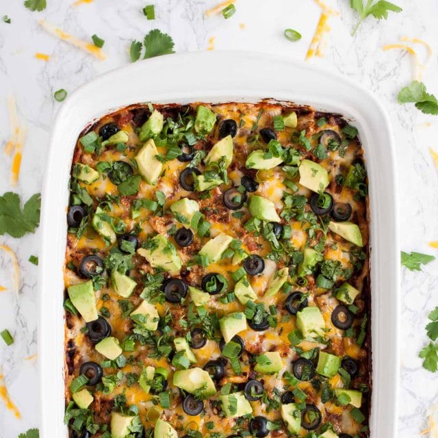 This easy chicken enchilada casserole is full of flavor and an ultimate crowd pleaser. It has the same great enchilada taste but with way less work!