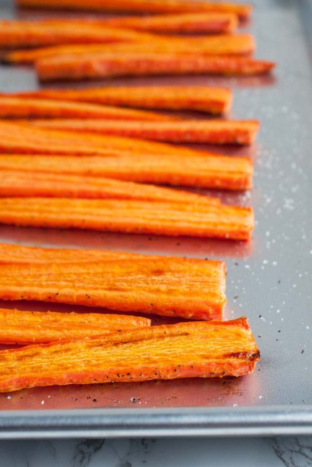 Cashew cream sauce is drizzled over perfectly roasted caramelized carrots in this easy, flavorful, absolutely delicious, naturally vegan dish.