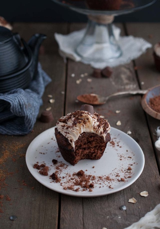 Chocolate peanut butter cupcakes that are outrageously decadent and rich but made healthy with oat flour, honey, and banana and coconut cream based frosting.